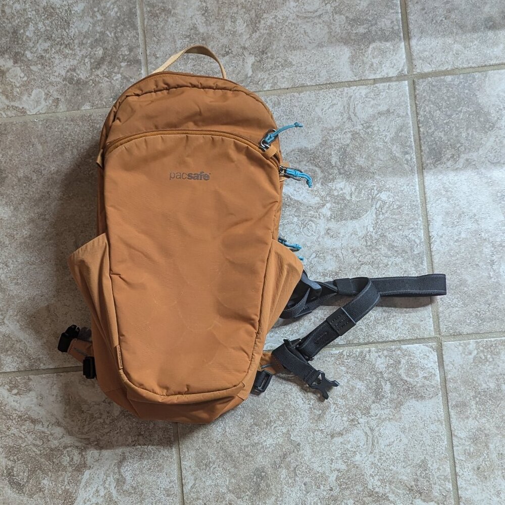 Pacsafe ECO 12L anti-theft sling backpack Orange